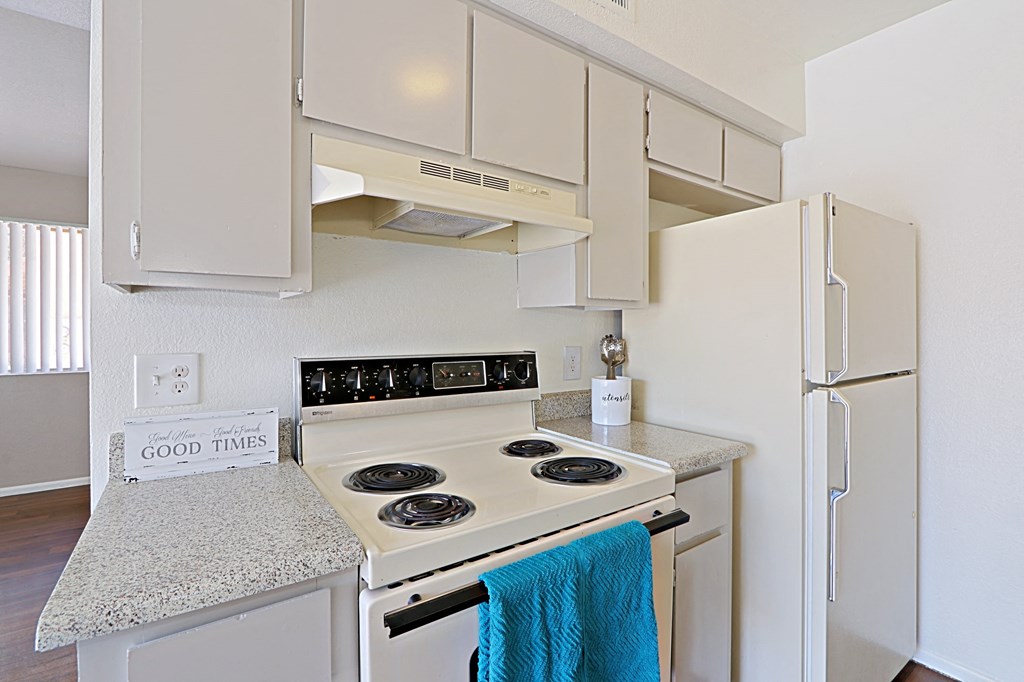 a kitchen with white appliances and granite counter tops and a white refrigerator