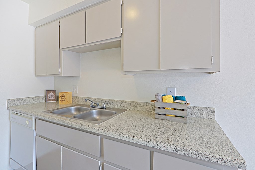 a kitchen with white cabinets and a sink
