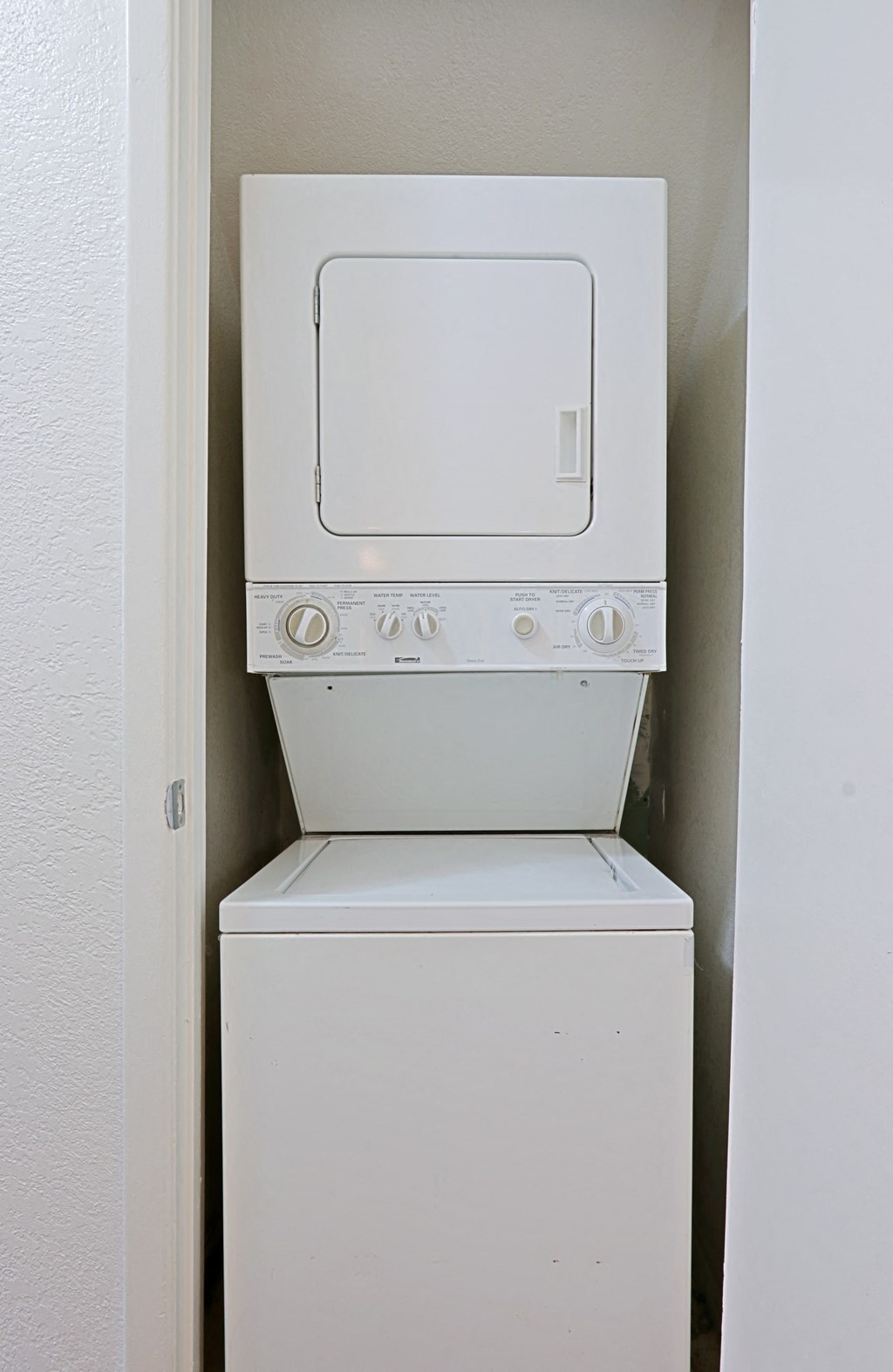 an empty laundry room with a washer and dryer