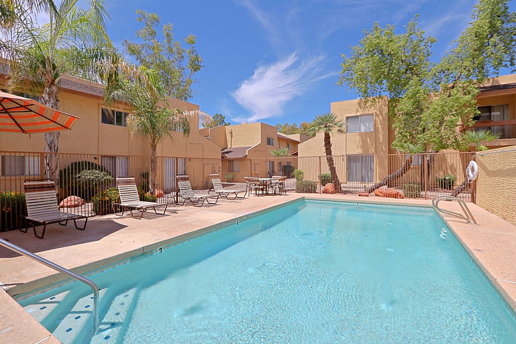 our apartments have a swimming pool and a patio with chairs