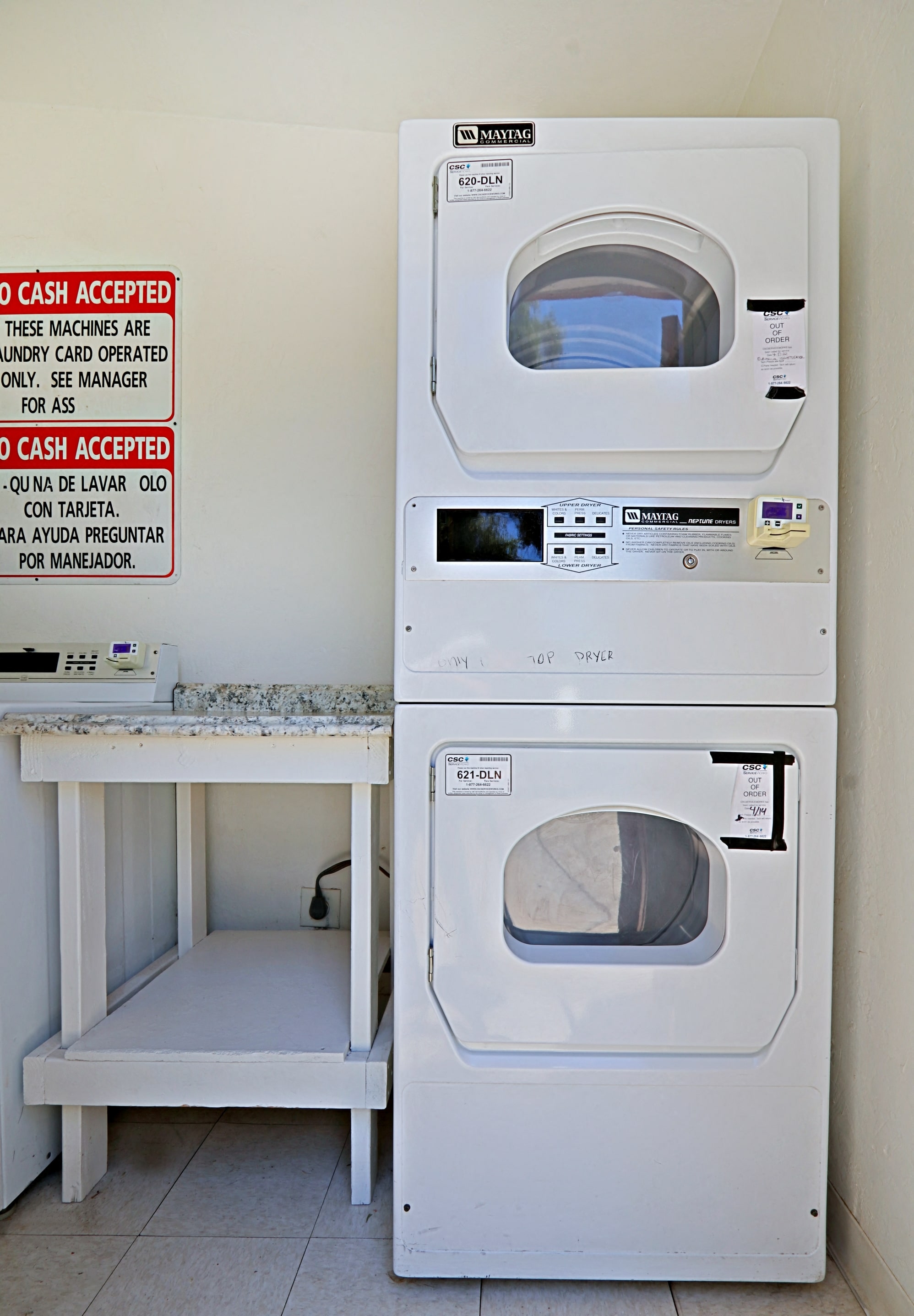 a washing machine and a microwave in a laundry room