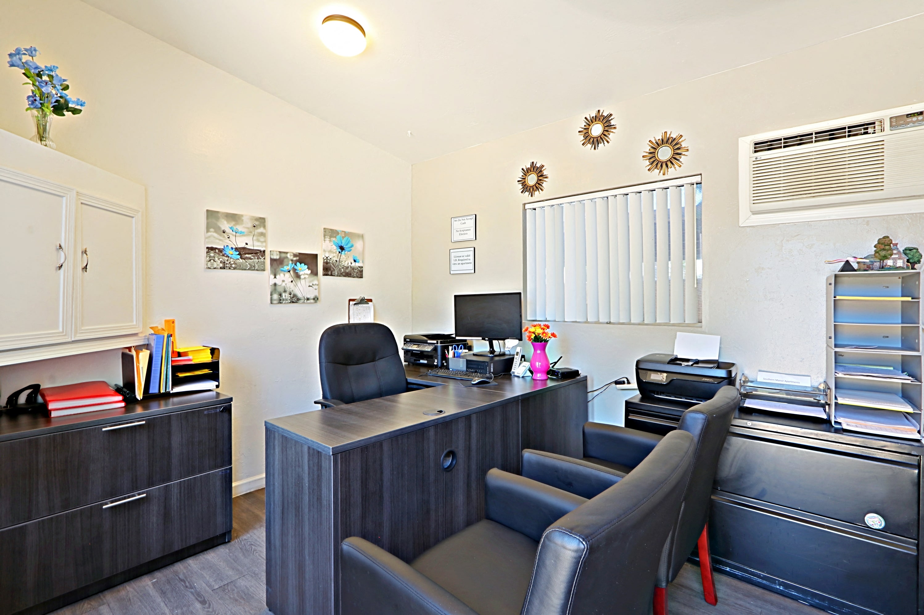 a office with chairs and a desk with a computer