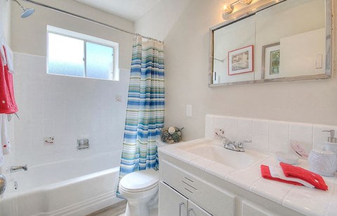 a bathroom with a sink toilet and a bath tub