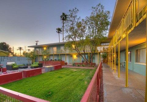 a building with a green lawn and a courtyard