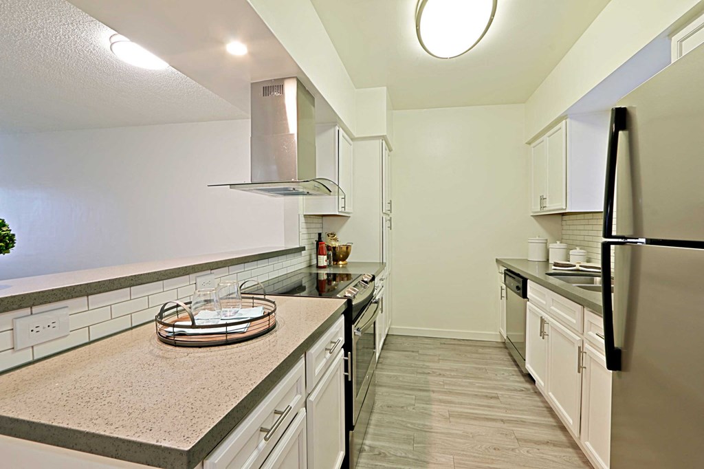 a kitchen with white cabinets and a counter top