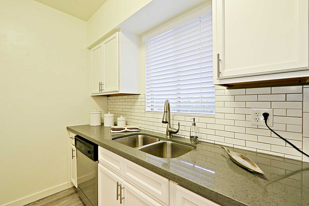 a kitchen with a sink and a window