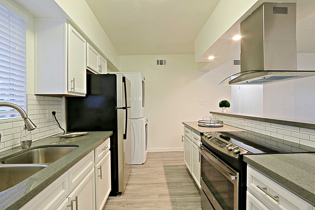 a kitchen with stainless steel appliances and white cabinets
