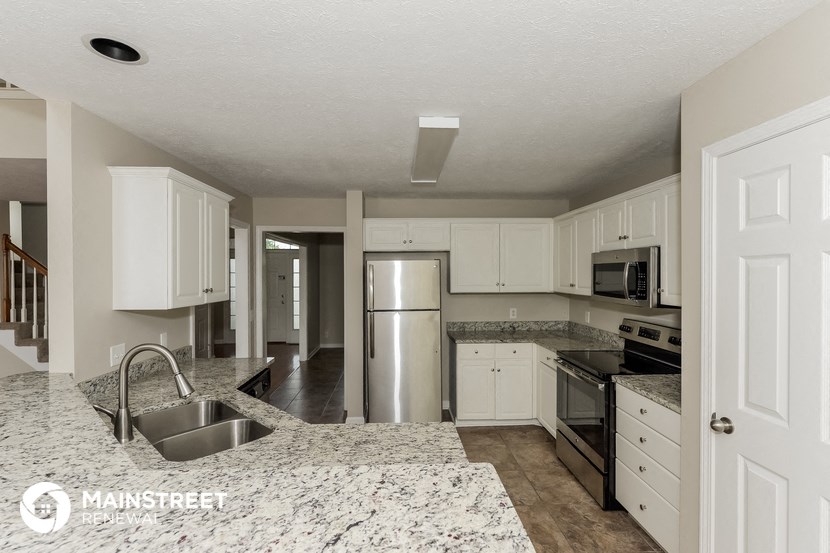 a kitchen with granite counter tops and stainless steel appliances