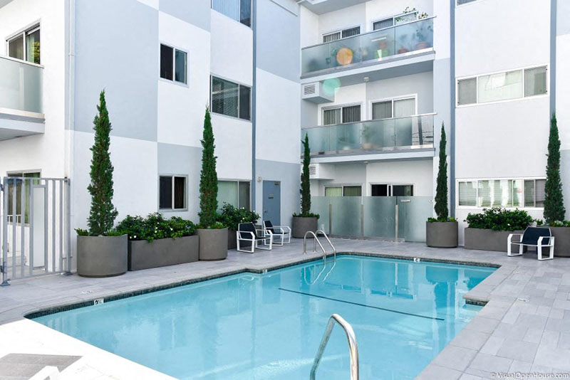 a swimming pool in front of an apartment building