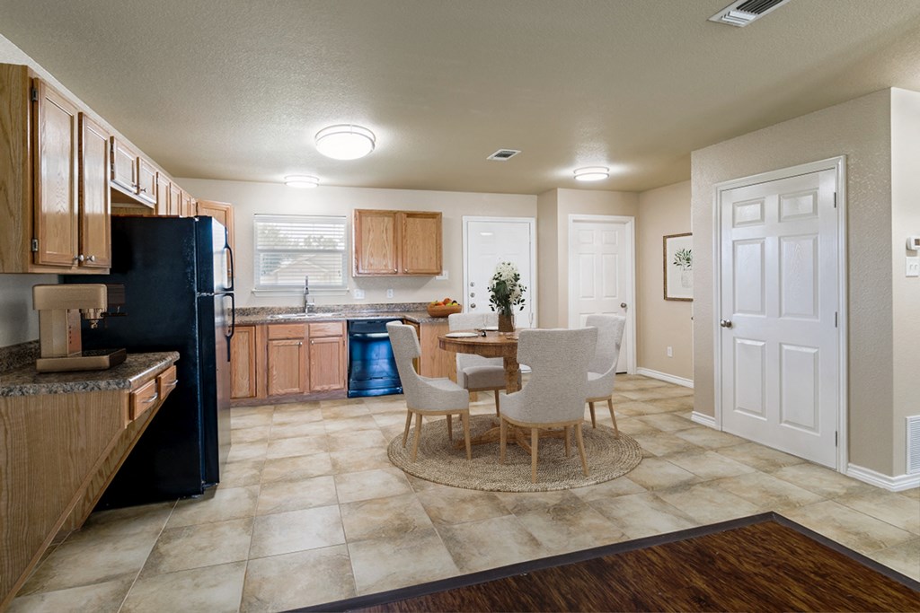 a kitchen and dining room with a table and chairs
