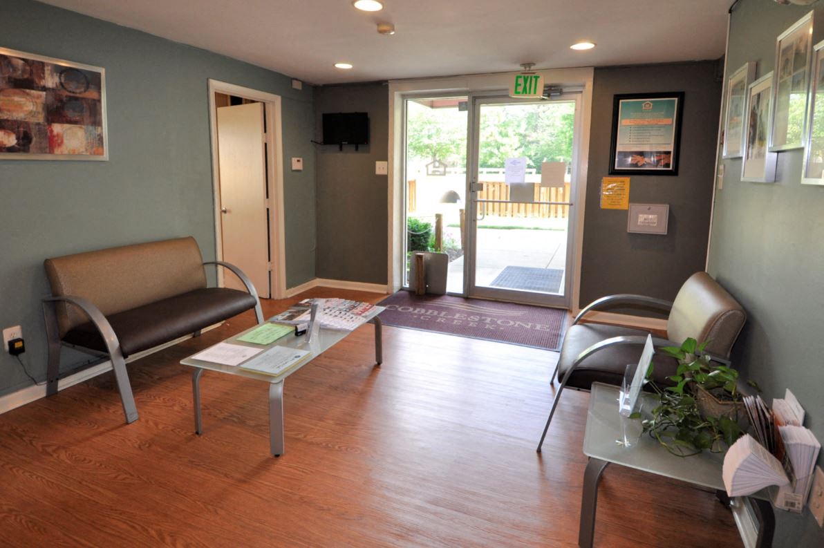 a living room with a table and chairs and a door