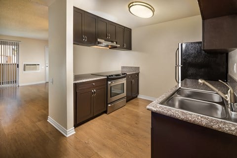 redesigned kitchen with stainless steel appliances and wood flooring at the preserve at great neck