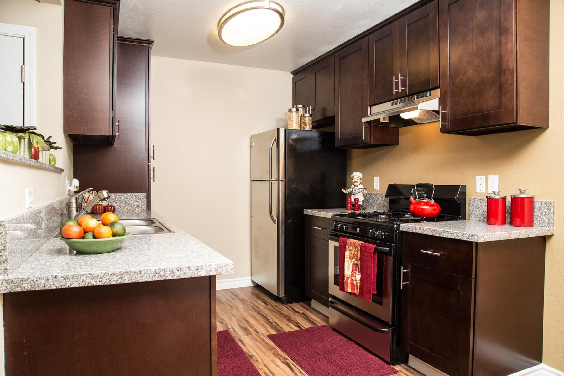 a kitchen with stainless steel appliances and granite counter tops