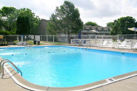 A large swimming pool with a metal fence around it.