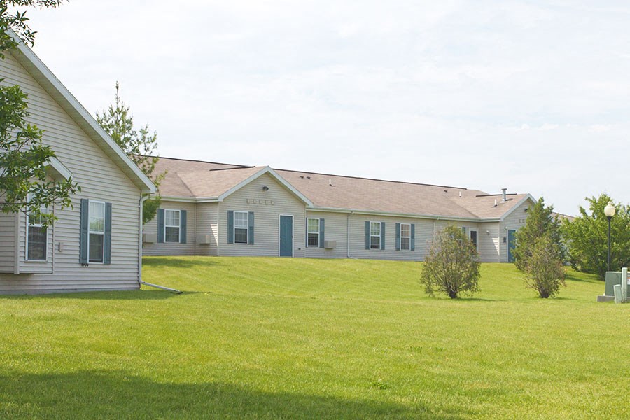 a white house with a yard in front of it