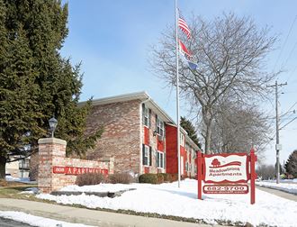 a building with a red sign and an flag in the snow