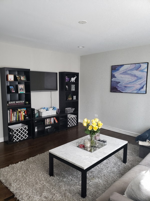a living room with a couch and a table with flowers