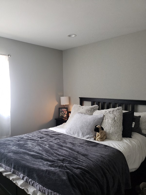 a bedroom with a bed and a teddy bear