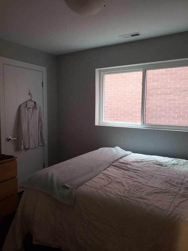 a bedroom with a bed and a window