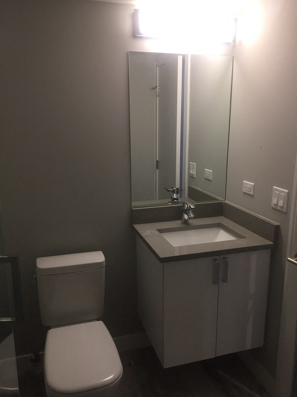 a small bathroom with a toilet sink and mirror
