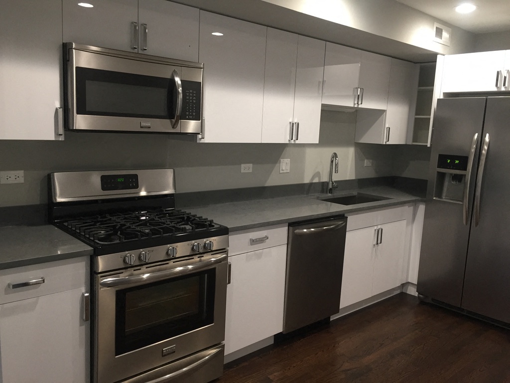 a kitchen with stainless steel appliances and white cabinets