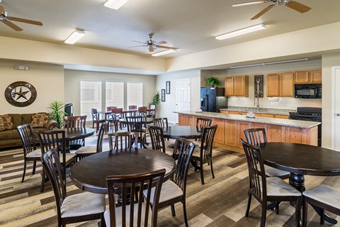 a dining room and kitchen with tables and chairs