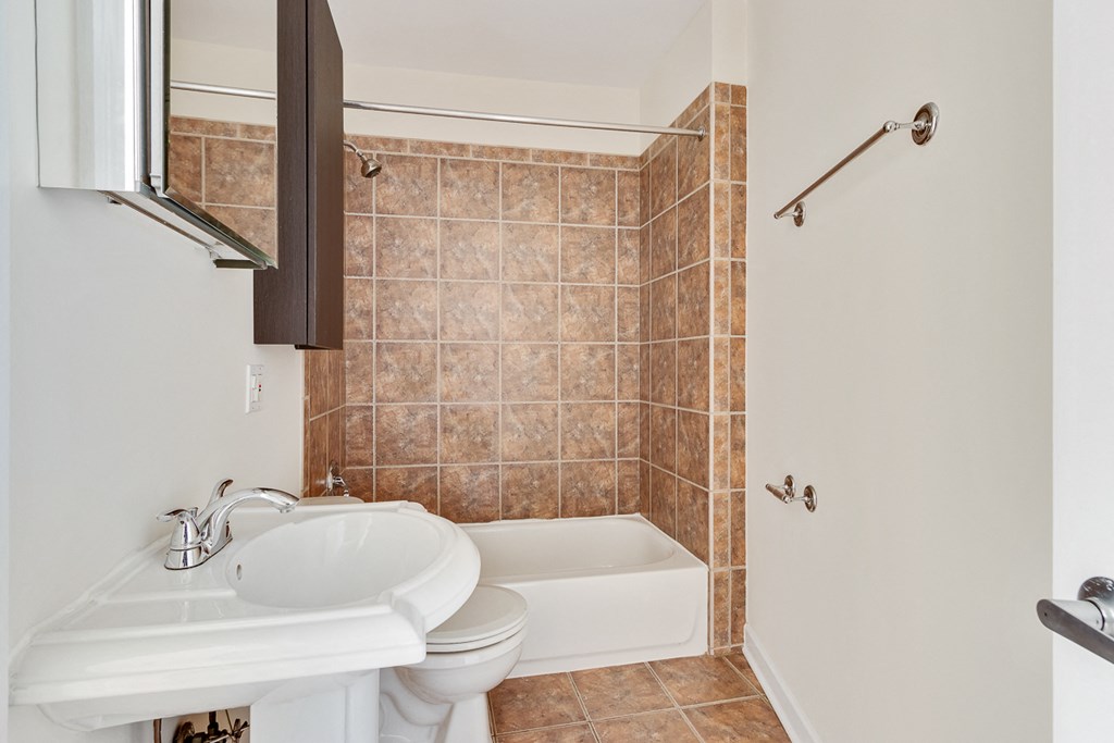 a bathroom with a sink and a toilet and a tub