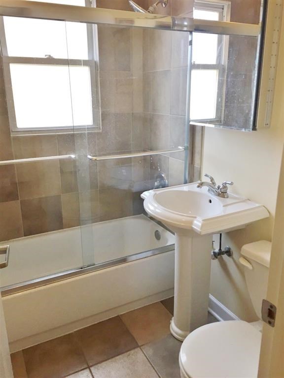 a bathroom with a sink toilet and a shower