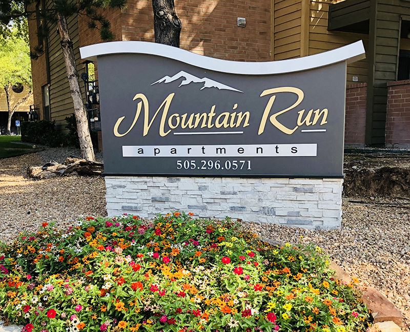 Albuquerque NM Apartments - Mountain Run Apartments - Exrerior Mountain Run Apartments Sign With Beautfiul Landcaping in Foreground - Photo Gallery 1