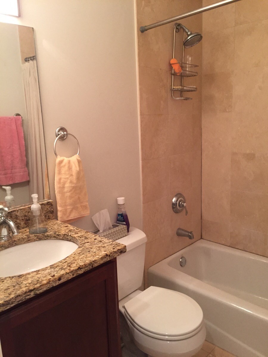 a small bathroom with a sink toilet and shower