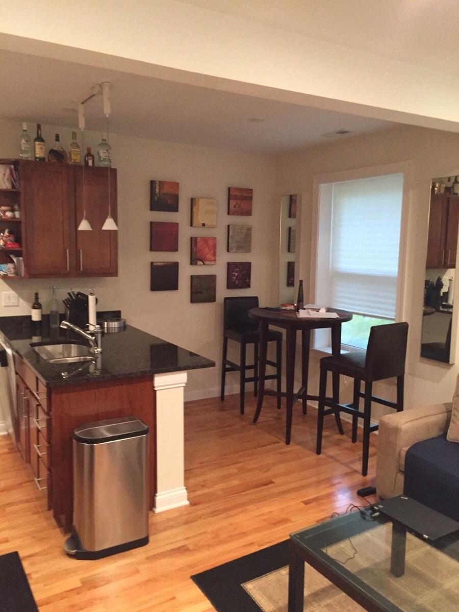 an open kitchen and living room with a table and chairs
