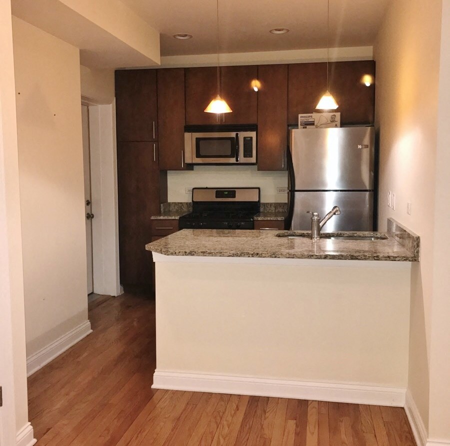 a kitchen with a counter top and a refrigerator
