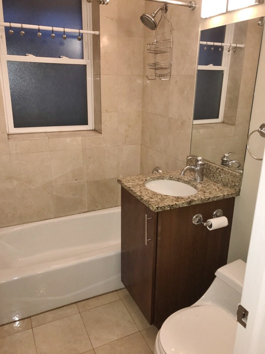 a small bathroom with a sink toilet and bath tub