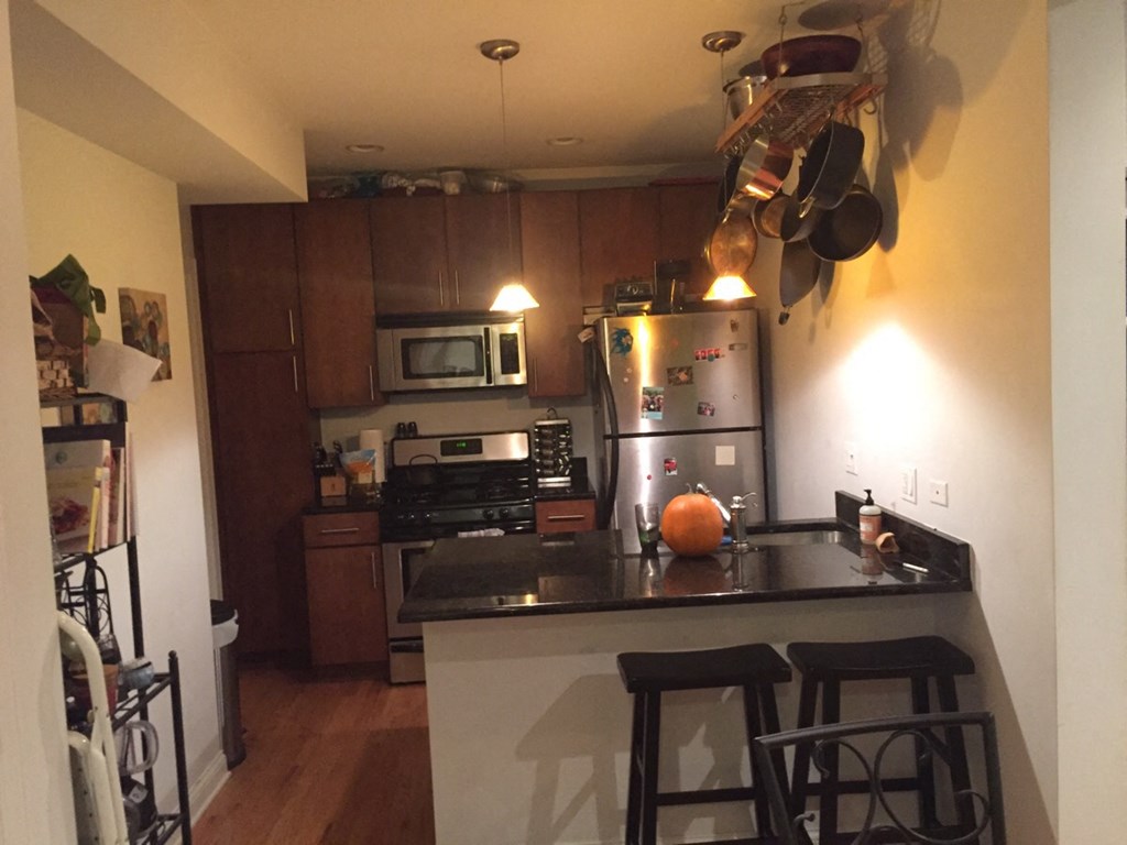 a kitchen with stainless steel appliances and a counter top