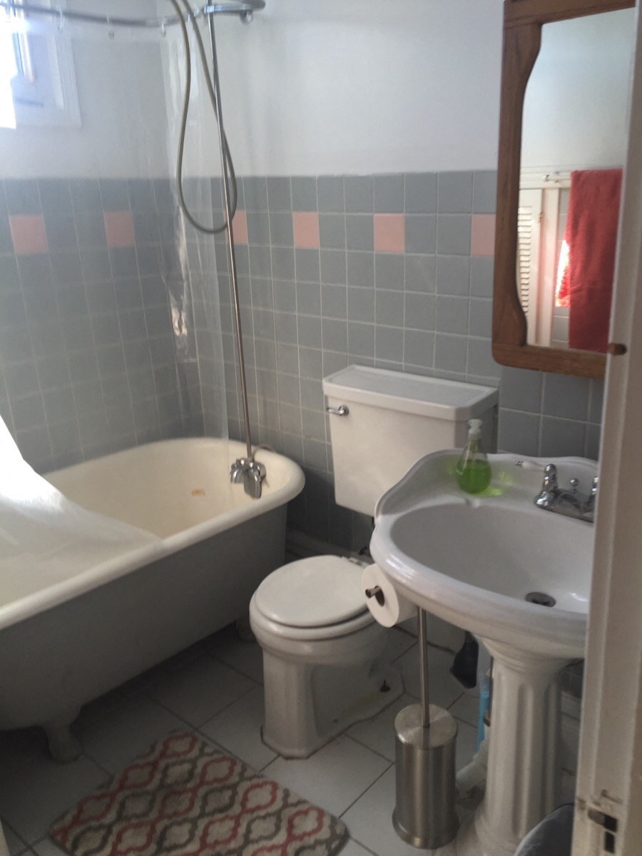 a small bathroom with a toilet sink and bath tub