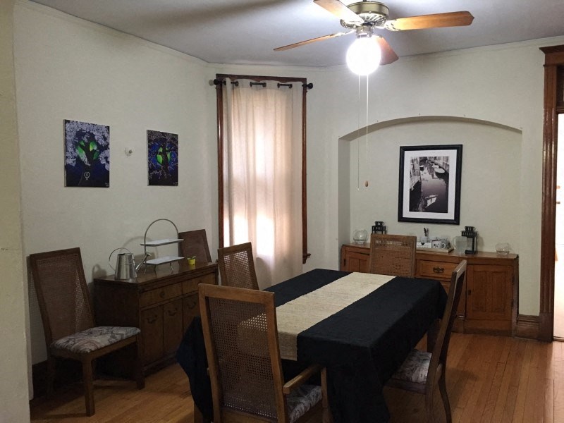 a dining room with a table and a ceiling fan