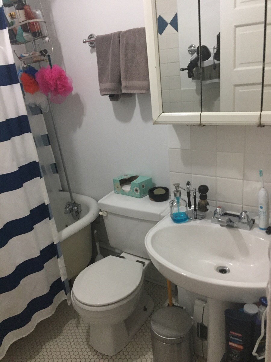 a small bathroom with a sink toilet and shower