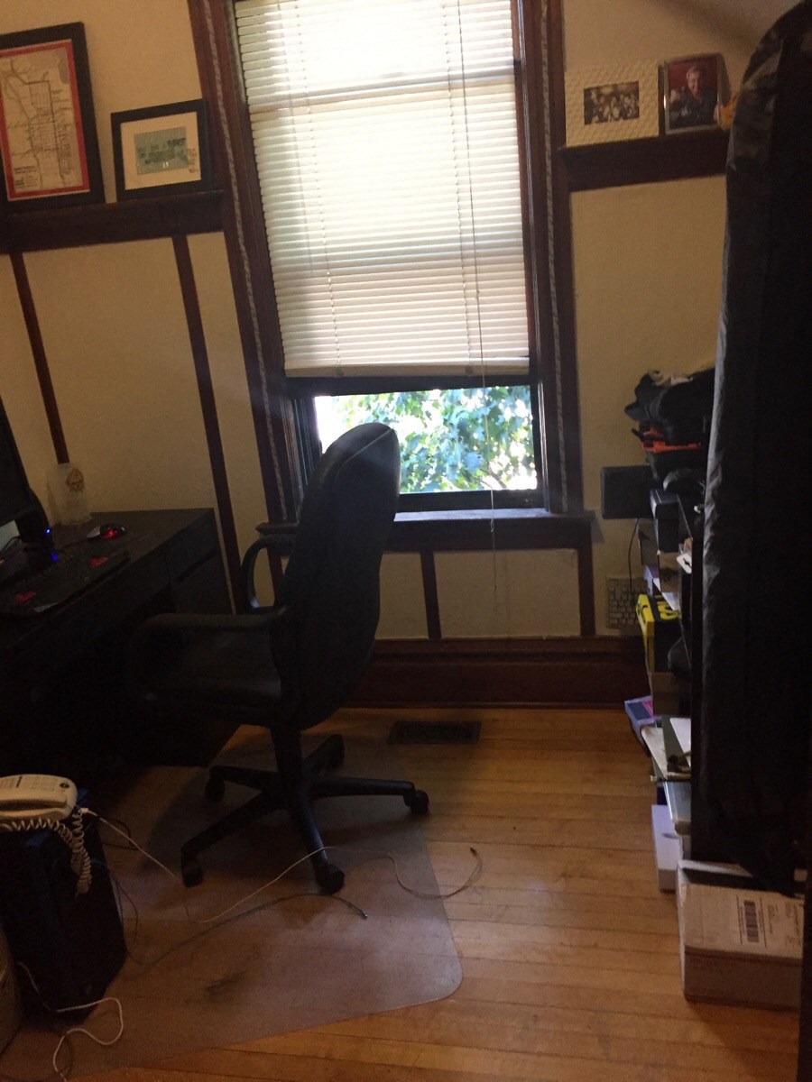 a desk chair sitting in front of a window