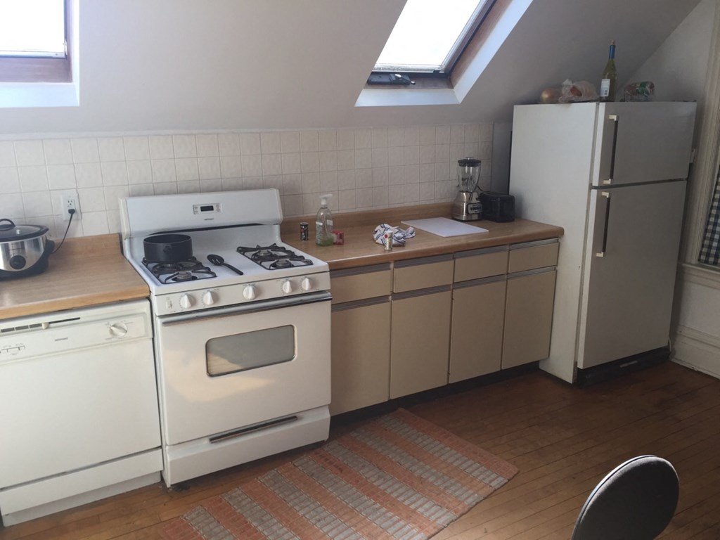 a kitchen with a stove and a refrigerator