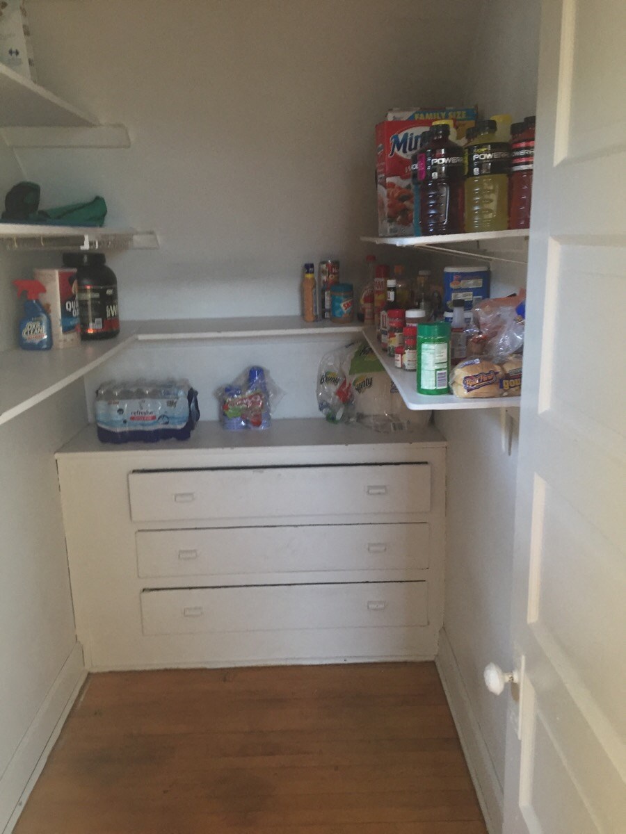 a small kitchen with shelves and drawers and