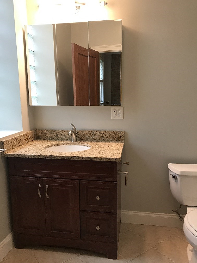a bathroom with a sink and a mirror and a toilet