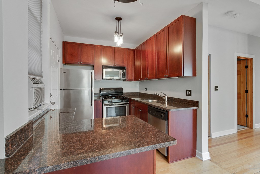 a kitchen with granite counter tops and stainless steel appliances