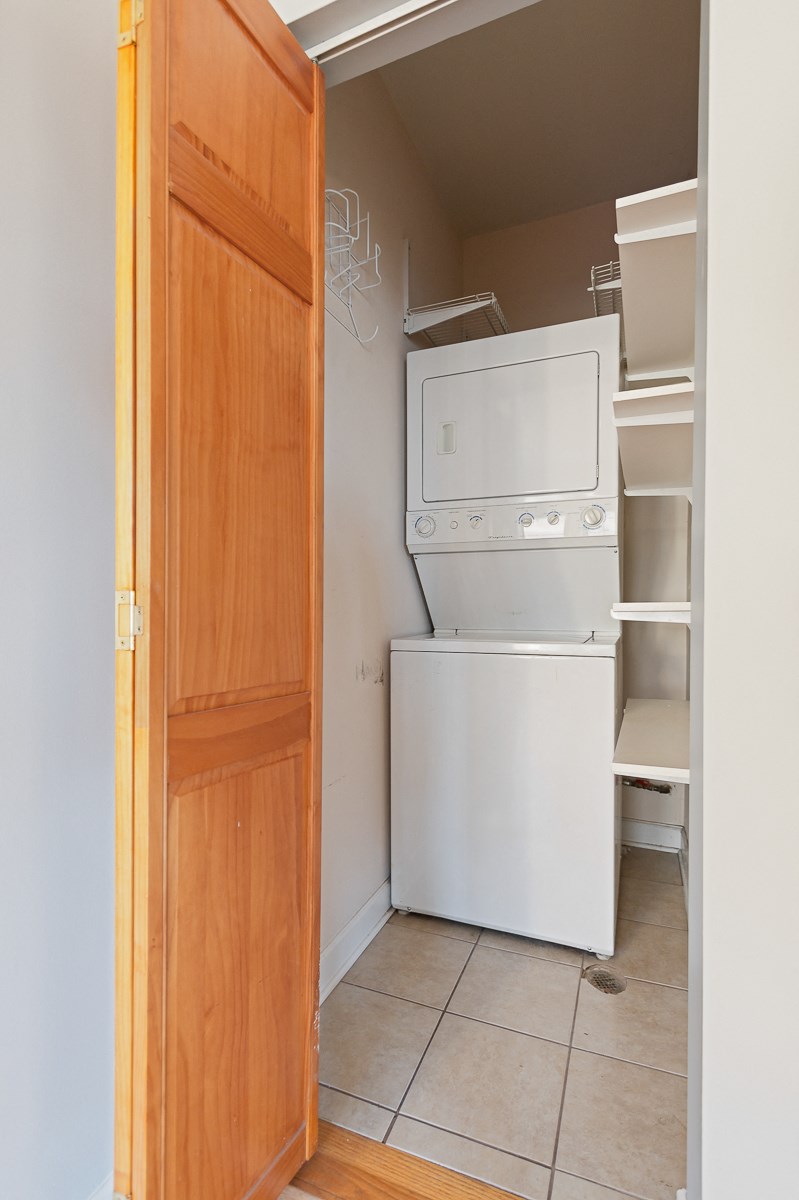 an empty laundry room with a washer and dryer in it