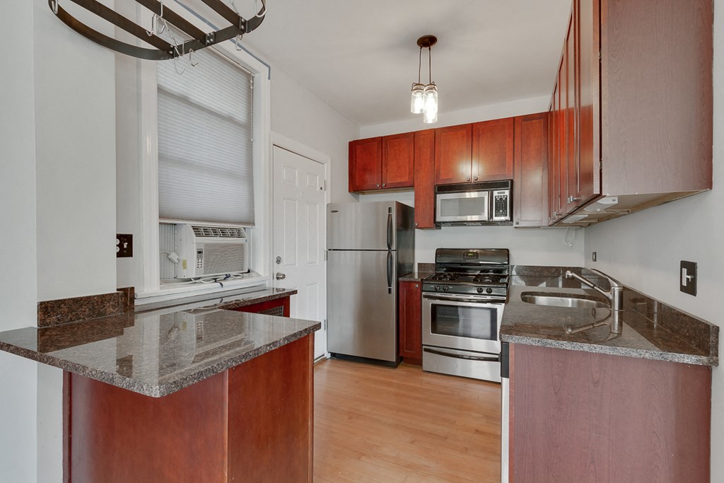 a kitchen with granite counter tops and stainless steel appliances