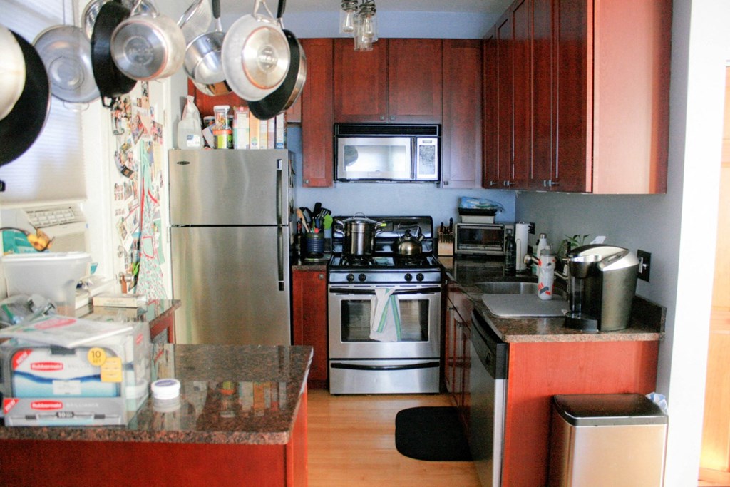 a kitchen with stainless steel appliances and wooden cabinets