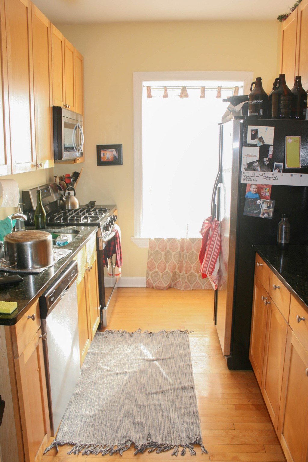 a kitchen with a rug in the middle of the floor