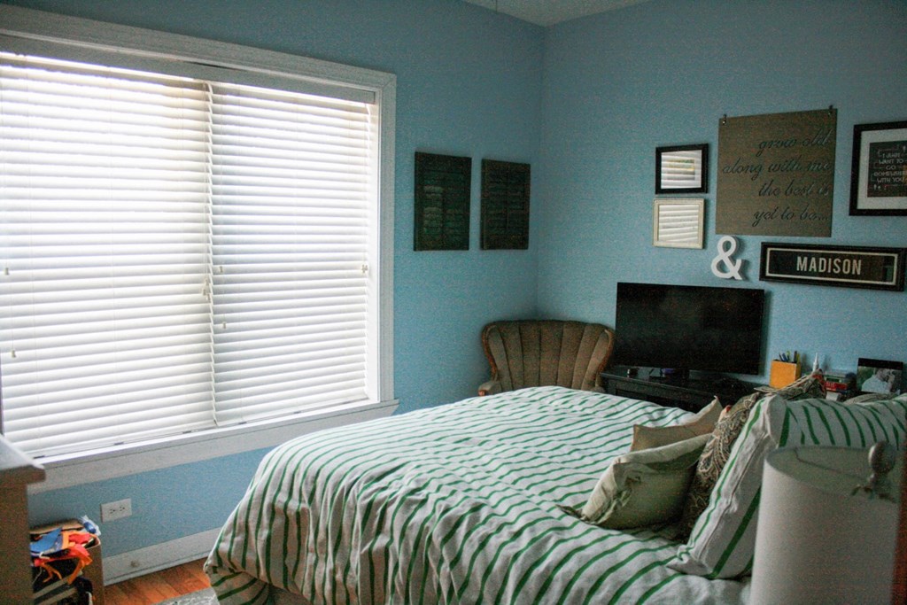 a bedroom with a bed and a tv in it