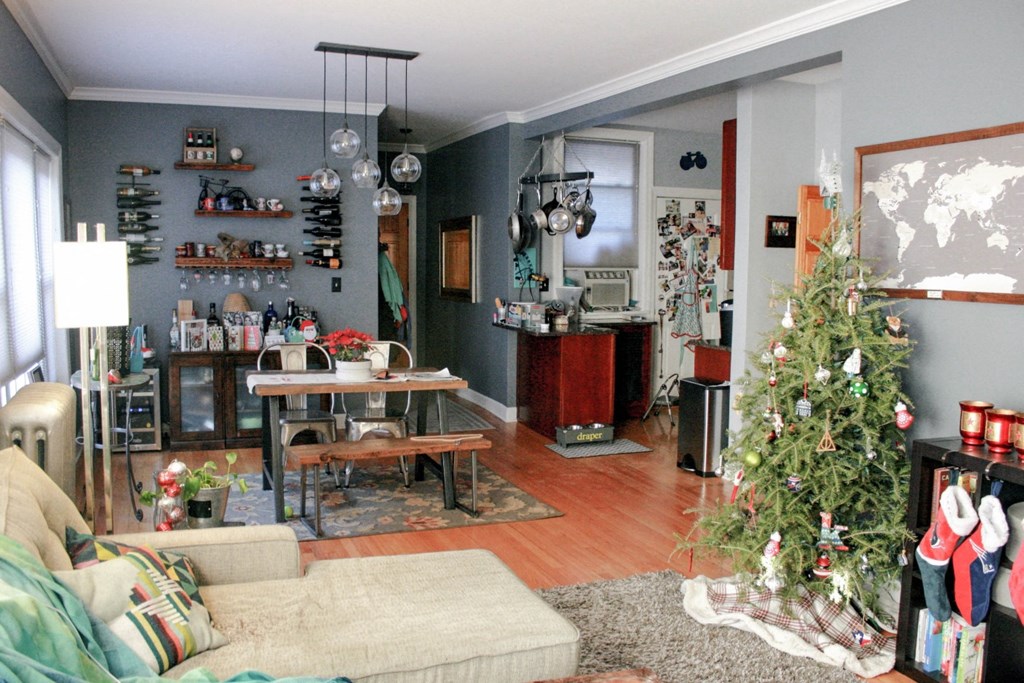 a living room and dining room with a christmas tree