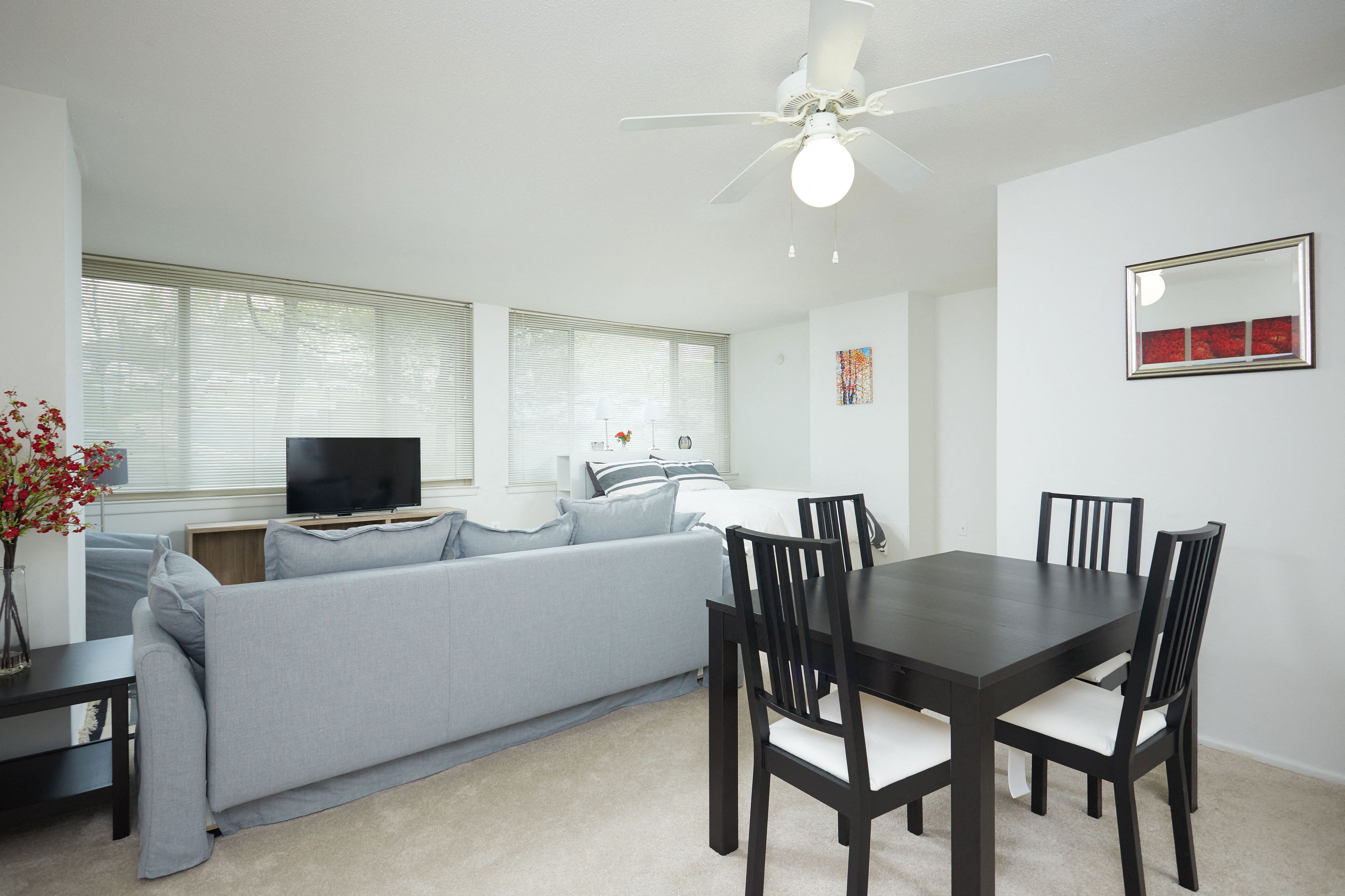 a living room and dining room with a couch and a table