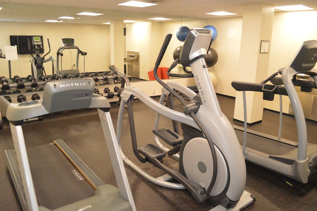 a gym with various machines and other equipment in a room